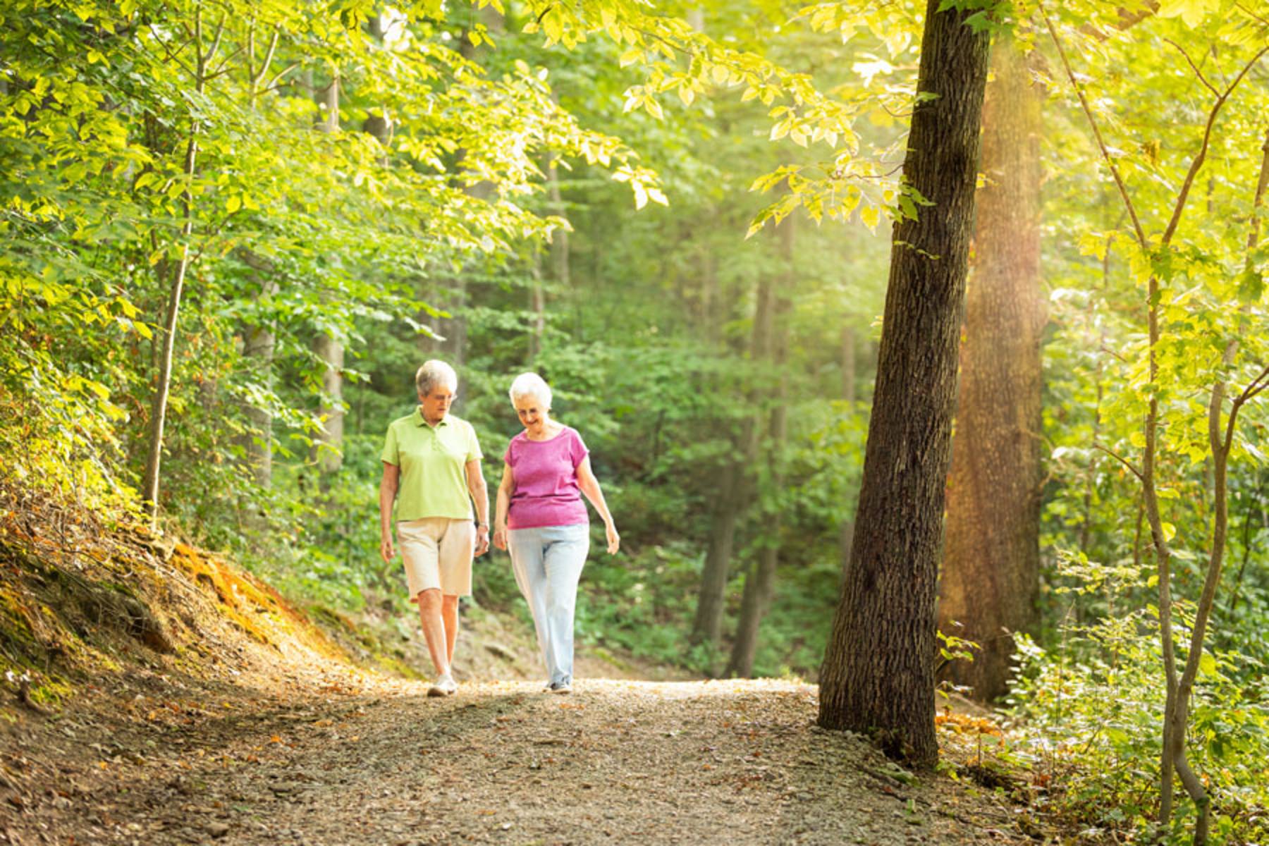 Senior women walking on a trail outside