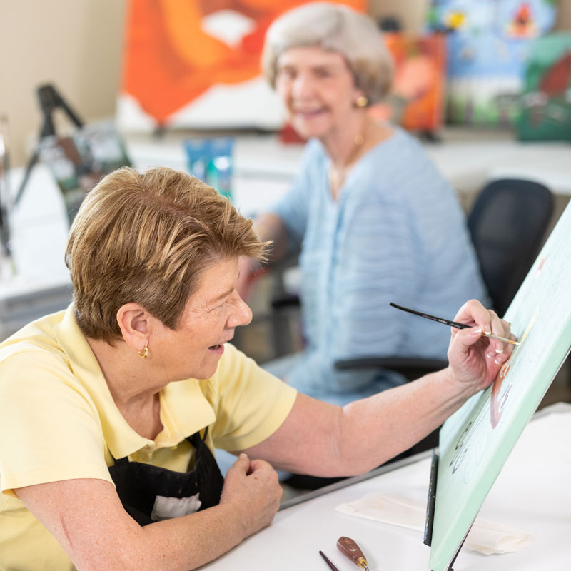Seniors painting in a painting class