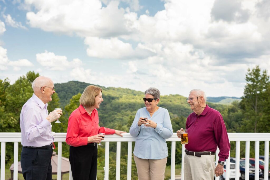 A group of seniors enjoy each others company out on a patio