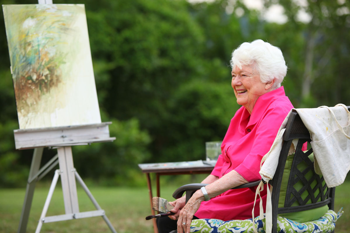 smiling woman at her painting