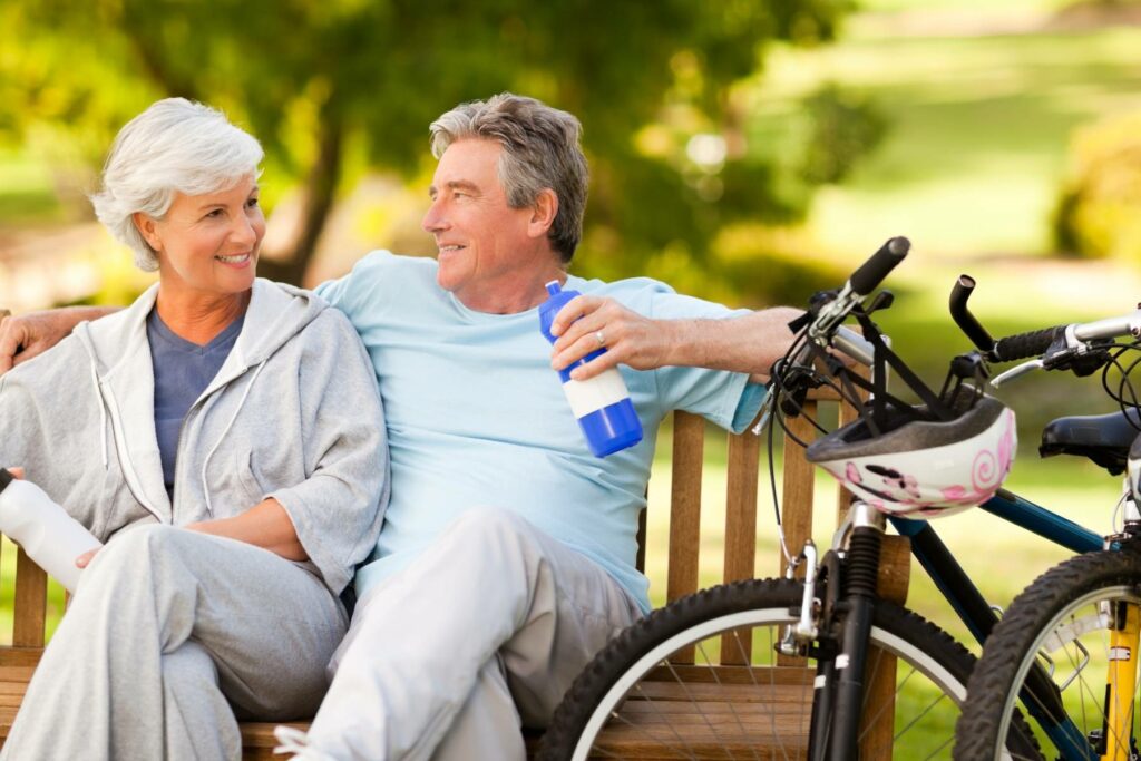 senior couple taking a break from bike riding