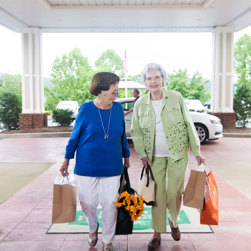 two women walking into an independent living community